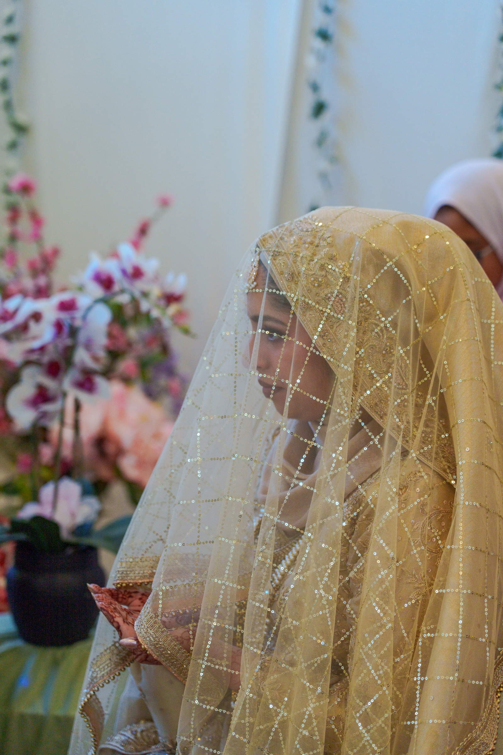 Bride in a sequined veil, a quiet moment before the ceremony
